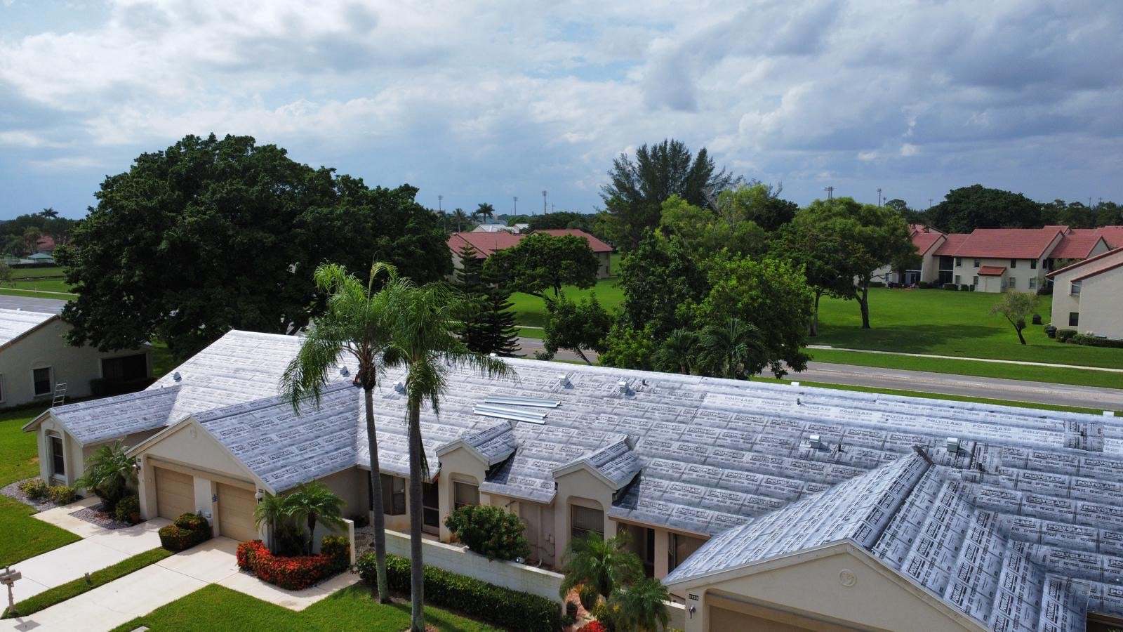 Roof repair crew working on a South Florida roof